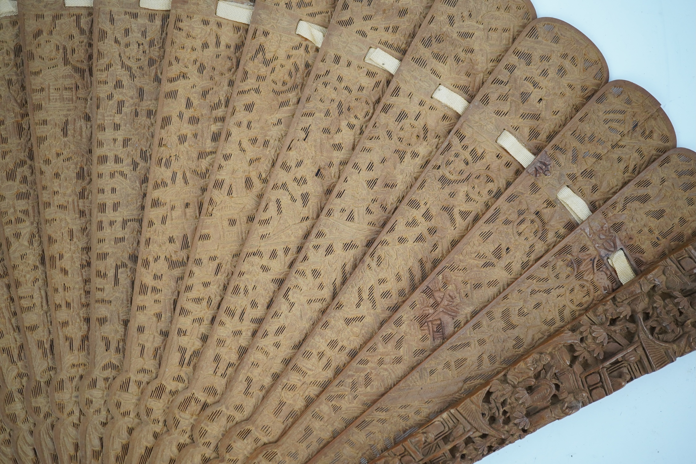 A fine Chinese sandalwood brise fan with finely carved sticks and guards, together with a mid 20th century silk calligraphic poetry LuYou fan, brise fan 38cm wide. Condition - minute damage to carving on one stick, sanda